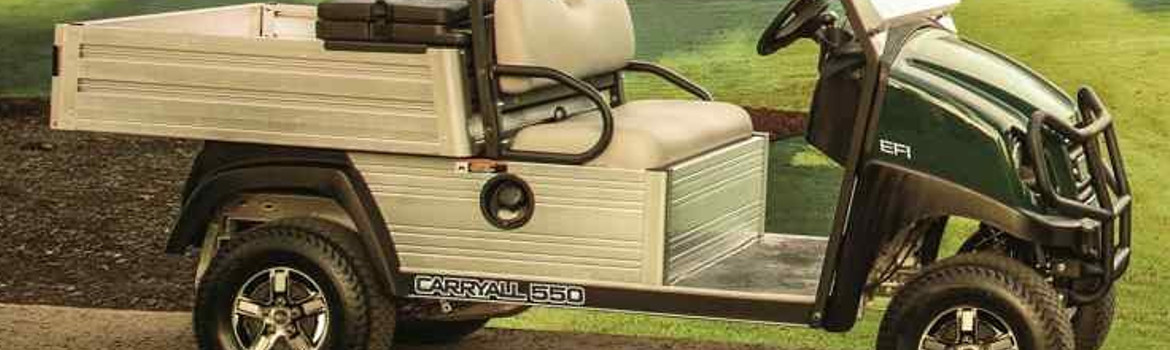 A green Club Car Carryall 550 utility vehicle in front of a green field. 
